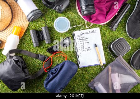 Camping checklist with various camp equipment. List of things for outdoors recreation and travel in nature - tent, first aid kit, cosmetics, accessori Stock Photo
