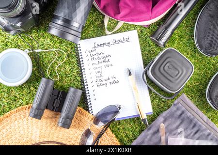 Camping checklist with various camp equipment. List of things for outdoors recreation and travel in nature - tent, first aid kit, cosmetics, accessori Stock Photo