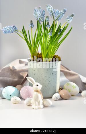 Easter composition with white rabbit, eggs and spring flowers. Easter still life Stock Photo