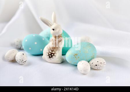Easter composition with white rabbit and eggs on a white background. The minimal concept. Stock Photo