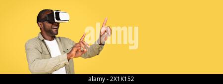 Glad shocked adult black man in casual and vr glasses Stock Photo
