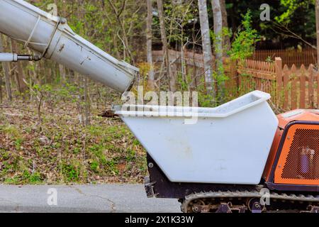 During construction of abuilding, wet cement was being discharged from cement truck chute into wheelbarrow track concrete buggy Stock Photo