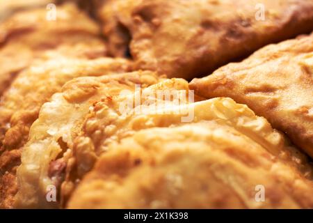 A close up of fried food, possibly apple pie or other baked goods, with a few pieces missing. The cuisine or dish could contain gluten as an ingredien Stock Photo