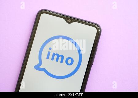 KYIV, UKRAINE - APRIL 1, 2024 Imo messenger icon on smartphone screen on purple table close up. iPhone display with app logo on lilac background Stock Photo