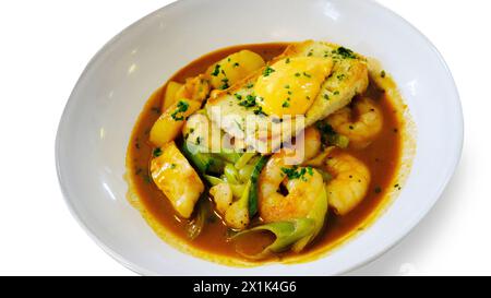 Studio shot of hot seafood with tiger prawns, fennel, toast, garlic and aioli cut out against a white background - John Gollop Stock Photo