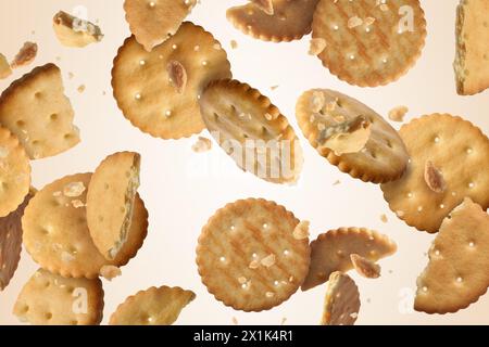 Tasty dry crackers falling on beige background Stock Photo