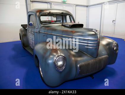 Three-quarters front view of an American,  Customized, Rat Rod, Classic Pickup Van, on display at the 2023 British Motor Show Stock Photo