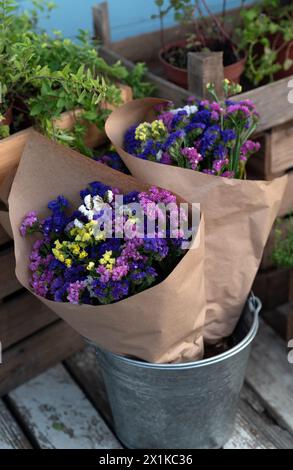 Bouquet colorful flowers Limonium or Statice (sea-lavender, caspia or marsh-rosemary) in craft paper. Country style. Concept photo for flower shops Stock Photo