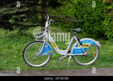 KYIV, UKRAINE - April 05, 2024. Urban bike is standing in the park. Bikenow. Ukrainian bike sharing service. Paid rental. High quality photo Stock Photo