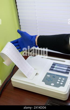 Heart ECG device. Electrocardiography of the heart in the hospital. A child is undergoing an electrocardiogram in the hospital. Treatment and examinat Stock Photo
