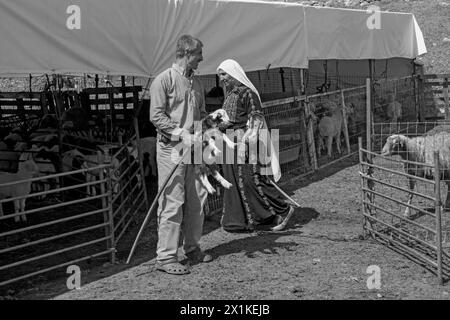 Bedouin family near a sheep pen in the desert Stock Photo