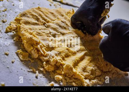 Professional Kneading Dough with Gloves in Bakery Stock Photo
