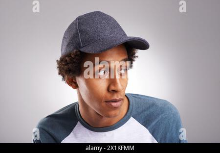 Cool guy, fashion and cap in studio for trendy style or funky and creative aesthetic. African man, generation z or male fashionista with confident Stock Photo