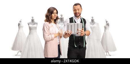 Bride to be choosing a wedding gown with a male fashion designer isolated on white background Stock Photo