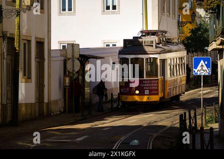 Tram 28 at the tram stop on the street Rua das Escolas Gerais in Lisbon, Portugal. February 1, 2024. Stock Photo