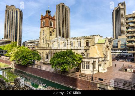 Medieval St Giles Cripplegate Church located on the Barbican Estate with brutalist high rise towers in background, London, England Stock Photo