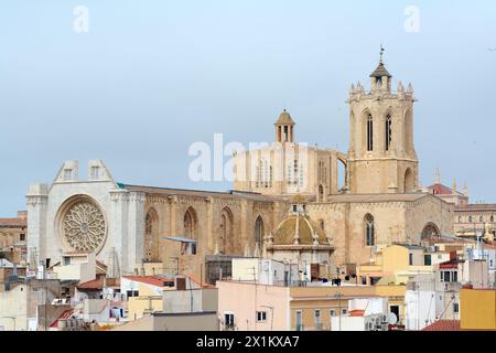 Tarragona, Spain - April 17, 2024: Featured image of the Tarragona Cathedral showcasing its historic and majestic architecture surrounded by colorful Stock Photo