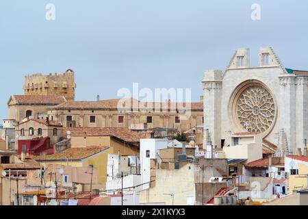 Tarragona, Spain - April 17, 2024: A glimpse at the historic Tarragona cathedral, with its detailed rose window and sturdy walls that tell stories of Stock Photo