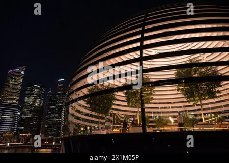 Singapore - 20 October 2022: Apple Marina Bay Sands at night with lighting inside. It is the World's First Floating Apple Store, designed by Foster + Stock Photo