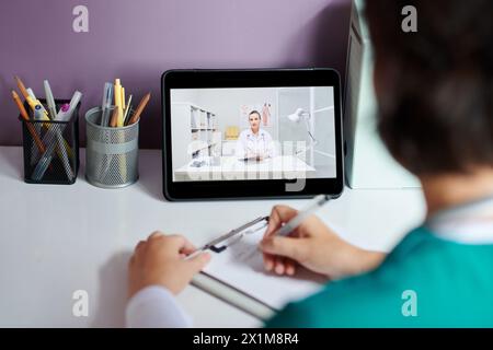 Doctor taking notes on tablet computer during stress ECG Stock Photo ...