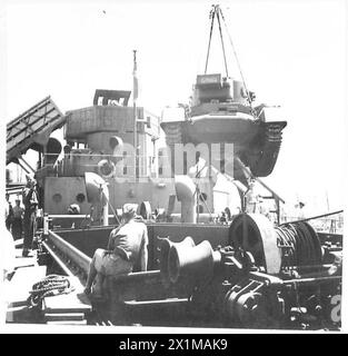 ON BOARD AN AFRICAN BOUND SHIP IN CONVOY - Unloading Valentine tanks , British Army Stock Photo