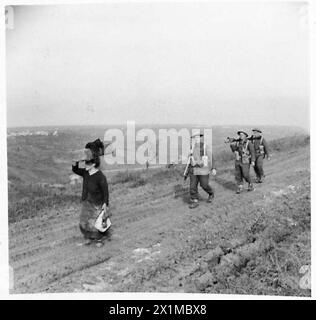 ITALY : EIGHTH ARMYRIVIER MORO AREA - Men of the Royal West Kents moving up to the front. The Italian woman in the photograph is returning to her home, British Army Stock Photo