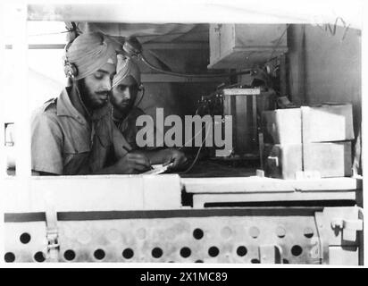 British Army signallers are operating in a Mobile Signal Station, handling communications equipment for military coordination. Stock Photo