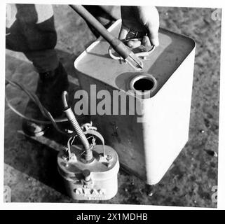 PHOTOGRAPHS TAKEN AT A MOBILE PETROL FILLING CENTRE R.A.S.C. - Showing the 'Ceag' inspection lamp being inserted into can, British Army Stock Photo