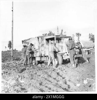 ITALY : EIGHTH ARMY FRONTSANGRO RIVER FRONT - With several men pushing, another vehicle is seen snatched from the engulfing claws of the Army's latest hoadache - Mud! , British Army Stock Photo