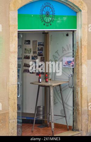 Tarragona, Spain - April 17, 2024: Image of the entrance to the Gypsy Association of Tarragona with a blue and green awning displaying photos in the w Stock Photo