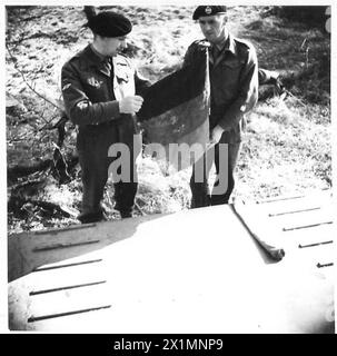 BRITISH FLAG FIRST TO CROSS RHINE IN TWO WARS - Lieut. Colonel Jolly [left] unfolding the flag. With him is RSM Halstead of Rochdale, British Army, 21st Army Group Stock Photo