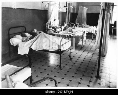 Italian prisoners work at a hospital in Tobruk, moving a wounded man on ...