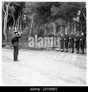 Lieutenant General Hood inspects medical services and receives the salute from the main guard at No.8 Convalescent Depot in North Africa, overseeing British Army healthcare operations. Stock Photo