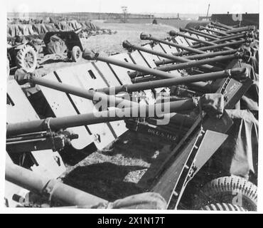 BRITISH EQUIPMENT FOR THE SECOND FRONT - A tractor towing 17-pounder anti-tank guns in position at a gun park, British Army Stock Photo