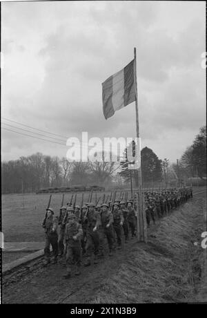 BELGIAN COMMANDOS IN TRAINING, UK, 1945 - A company of the 2nd Battalion, 2nd Belgian Brigade march past the Belgian flag during their Commando training, somewhere in Britain, Stock Photo