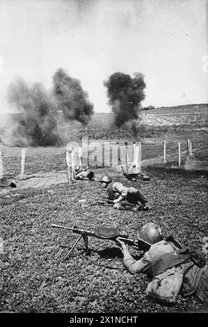 THE SOVIET ARMY ON THE EASTERN FRONT, 1941-1945 - Russian infantry advance 'under fire', summer 1942. Some troops are using wire-cutters to cut through a fence, while the soldier in the foreground provides support with his Degtyarev DP light machine-gun, Stock Photo