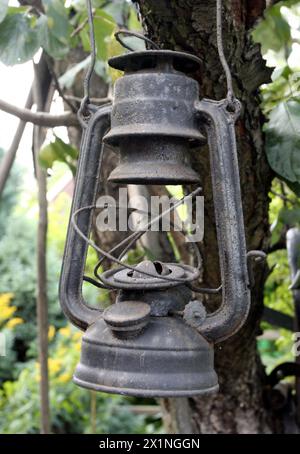 Old worn rusty kerosene hurricane lamp. Stock Photo