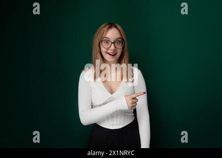 Woman Wearing Glasses Pointing at Something Stock Photo