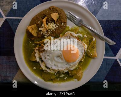 Typical chilaquiles mexican food for breakfast in Mexico. Top down view on table flat lay. Stock Photo