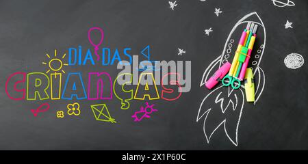 School stationery, drawn rocket and text DIA DAS CRIANCAS (Children's Day) on dark background Stock Photo