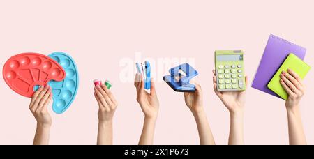 Many hands with school supplies on light color background Stock Photo