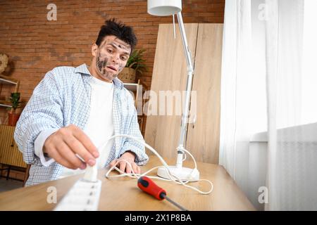 Electrocuted young man with burnt face at home Stock Photo