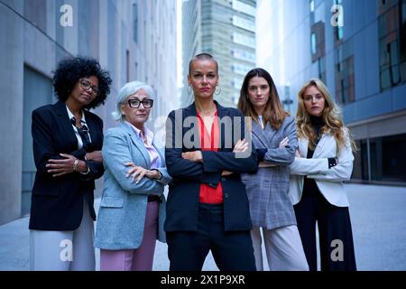 Portrait of multiracial and diverse ages business women in formal suits posing smiling Stock Photo