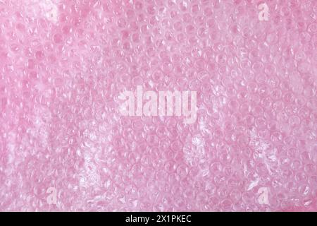 Transparent bubble wrap on pink background, top view Stock Photo