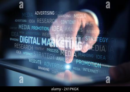 Digital marketing. Businessman touching tablet, closeup. Virtual word cloud over device Stock Photo