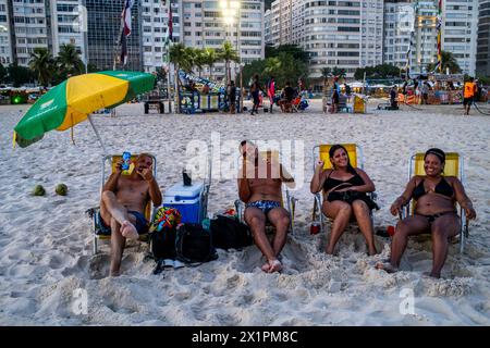 Local People Sitting On Copacabana Beach At Sunset, Rio de Janeiro, Rio de Janeiro State, Brasil. Stock Photo
