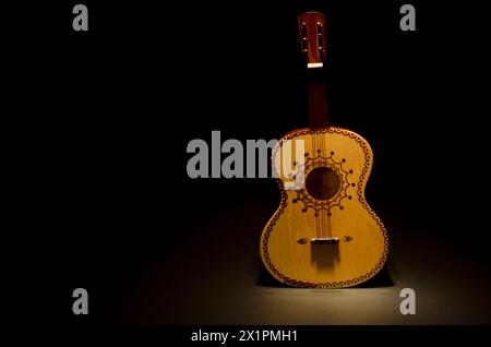 A miniature representation of a  mexican 'Guitarron' , an acoustic bass guitar played traditionally by Mariachi groups. Stock Photo