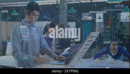 Diverse team working on computers in high-tech office Stock Photo