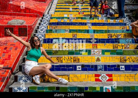 A Female Tourist Poses For A Photo On The Lapa Steps (Escadaria Selaron) Rio de Janeiro, Brasil. Stock Photo