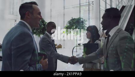 Diverse group of professionals greeting each other in office Stock Photo